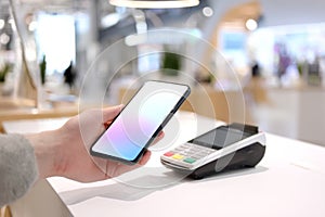 Smartphone payment at a modern retail store with contactless technology