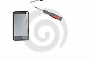 Smartphone and precision screwdrivers over white