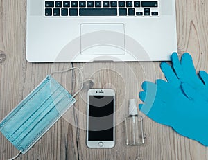 Smartphone and protective mask on the office Desk.