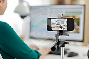 smartphone recording woman working in video editor