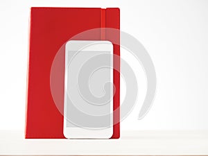 Smartphone and red notebook, analogue, digital, information stor