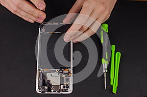 smartphone repair on black background. Replacement of a broken screen