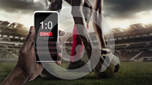 Smartphone screen with mobile app for betting and score, sportsman on background