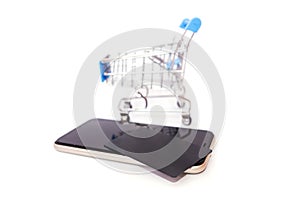 Smartphone with shopping cart, black credit card on a white background. Online shopping, discount and sales concept