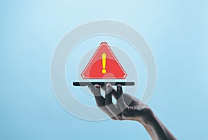 smartphone shows a warning sign of system failure, notification spam. concept caution danger if a computer is attacked cyber error