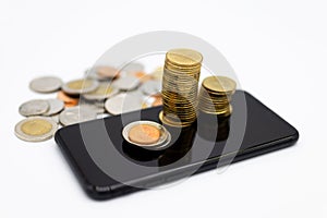 Smartphone with stack of coins , Online to Offline business, create idea of marketing. Image use for retail business, online