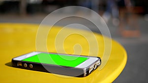 A Smartphone On Table With Green Screen