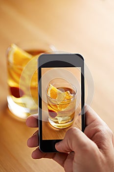 Smartphone taking a picture of cocktail