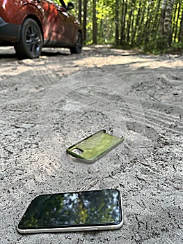 smartphone thrown out of the car lies on the road. concept of stress from information overload stress