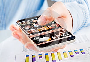 Smartphone with transparent screen in human hands.