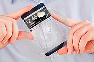 Smartphone with transparent screen in human hands.