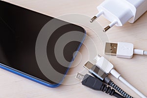 Smartphone, USB charger, micro USB cables photo