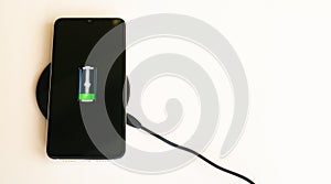 Smartphone wireless charging on induction charger. Wireless charger. Copy space