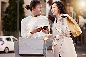 Smartphone, women and happy with paper bag for online shopping, sale and retail together outdoor by mall. People