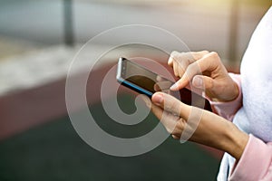 Smartphone in women`s hands close-up. Using the phone, fingers on the touch screen of the gadget. Text messages, doing business, I