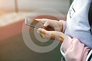 Smartphone in women`s hands close-up. Using the phone, fingers on the touch screen of the gadget. Text messages, doing business, I