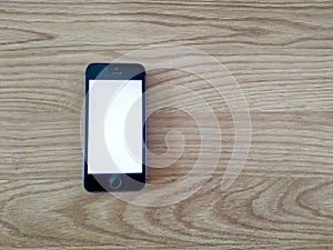 Smartphone is on wooden table