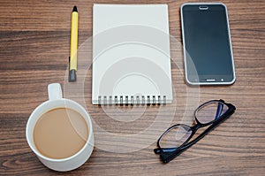 Smartphonem pen, notebook,eyeglasses and coffee