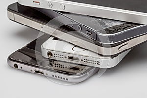 Smartphones are placed one to another, laying on the table side is visible only