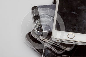 Smartphones are placed one to another, laying on the table side is visible only