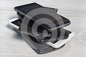 Smartphones stacked on top of each other are on the counter. photo