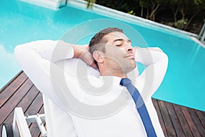 Smarty dressed man relaxing on sun lounger