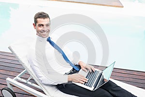 Smarty dressed man using laptop