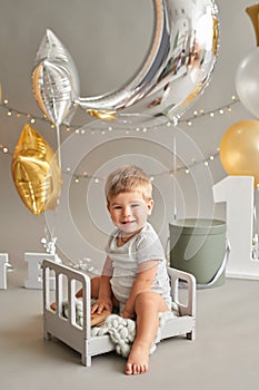 Smash cake party. Little cheerful birthday boy with first cake. Happy infant baby celebrating his first birthday. Decoration and