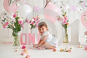 Smash cake party. Little cheerful birthday girl with first cake. Happy infant baby celebrating his first birthday. Decoration and