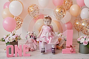 Smash cake party. Little cheerful birthday girl with first cake. Happy infant baby celebrating his first birthday. Decoration and