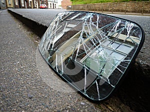 Smashed car rear view mirror terrace house