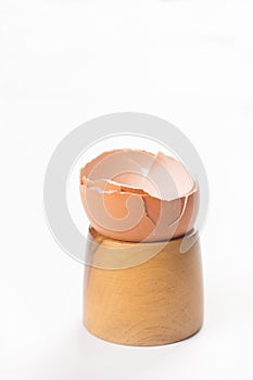 Smashed Egg Shell on the wooden egg holder isolated above white background