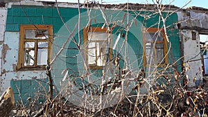 Smashed glass Window with old wooden frame on grunge wall damaged house. Old abandon building. Front facade of an