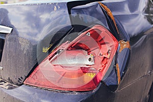 Smashed Headlight. Close-up of a smashed headlight on a blue car.