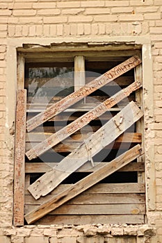 smashed a shot of an old brick building planked window at the Donbass in Ukraine