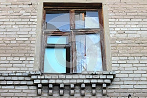 Smashed a shot of an old brick building planked windows at the Donbass in Ukraine