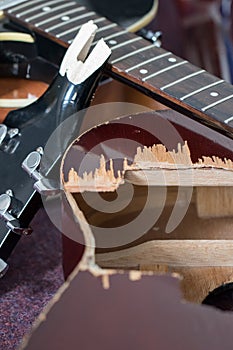 Smashed up guitars close-up selective focus. Broken guitar bits