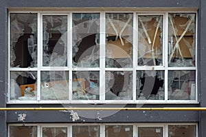 Smashed window broken glass break. Destroyed building broken frame window plastic. Aftermath bombed building window