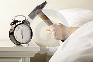 Smashing Alarm Clock with Hammer photo