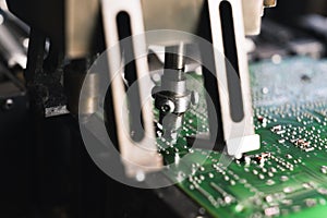 SMD surface-mount device working on printed circuit board PCB mounting electrical components. Modern precision