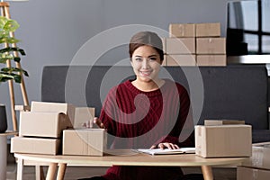 SME business entrepreneurs small in asia Preparing cardboard boxes in home office Small business operators preparing to