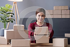 SME business entrepreneurs small in asia Preparing cardboard boxes in home office Small business operators preparing to