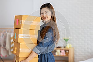 SME entrepreneur Young Asian women lifting packaging order for Online shopping at home,Cheerful and Happy with box for packaging i