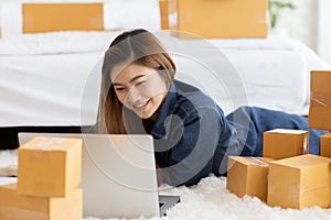 SME entrepreneur of Young Asian women working with laptop for Online shopping at home,Cheerful and Happy with box for packaging in