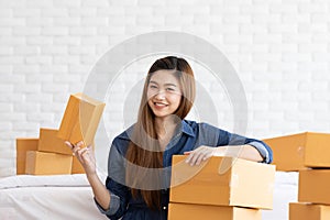 SME entrepreneur of Young Asian women working with laptop for Online shopping at home,Cheerful and Happy with box for packaging in