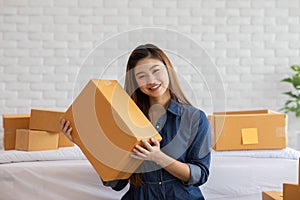 SME entrepreneur of Young Asian women working with laptop for Online shopping at home,Cheerful and Happy with box for packaging in