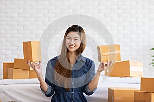 SME entrepreneur of Young Asian women working with laptop for Online shopping at home,Cheerful and Happy with box for packaging in