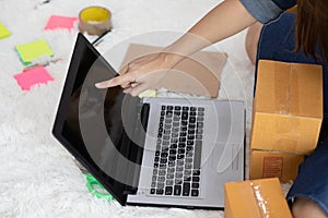 SME entrepreneur of Young Asian women working with laptop for Online shopping at home and talking with customer to delivery order