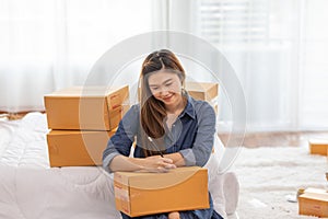 SME entrepreneur of Young women working with laptop and writing customer address for send order Online shopping at home