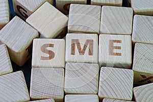 SME, Small and medium-sized enterprises, startup business concept, cube wooden block with alphabet combine the word SME on black